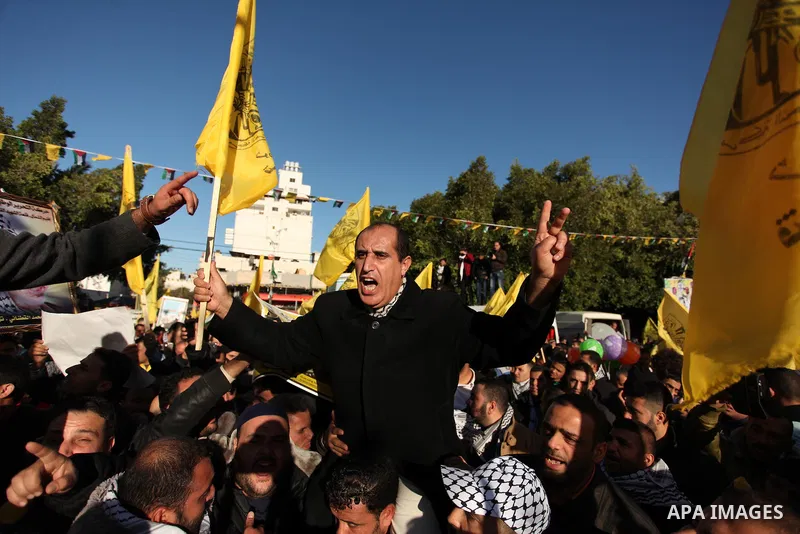 Supporters of the Fatah movement take part in a rally in Gaza City on December 31, 2016, marking the 52nd anniversary of its creation.. Photo by Ashraf Amra