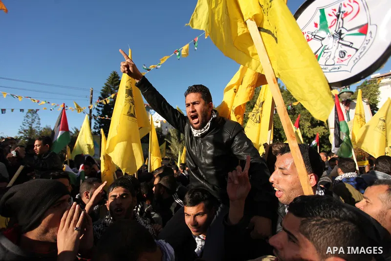 Supporters of the Fatah movement take part in a rally in Gaza City on December 31, 2016, marking the 52nd anniversary of its creation.. Photo by Ashraf Amra