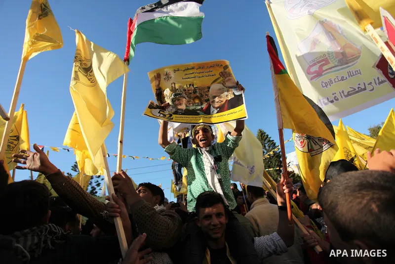 Supporters of the Fatah movement take part in a rally in Gaza City on December 31, 2016, marking the 52nd anniversary of its creation.. Photo by Ashraf Amra