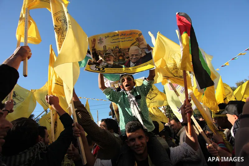 Supporters of the Fatah movement take part in a rally in Gaza City on December 31, 2016, marking the 52nd anniversary of its creation.. Photo by Ashraf Amra