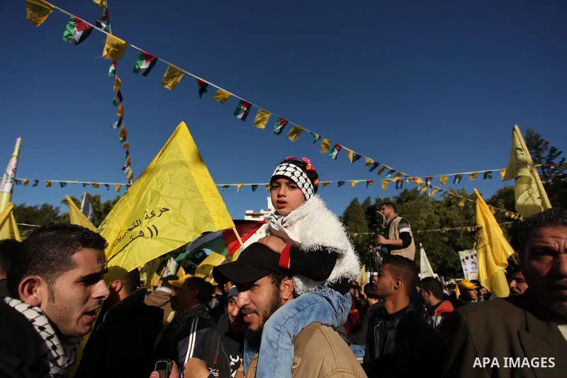 Supporters of the Fatah movement take part in a rally in Gaza City on December 31, 2016, marking the 52nd anniversary of its creation.. Photo by Ashraf Amra