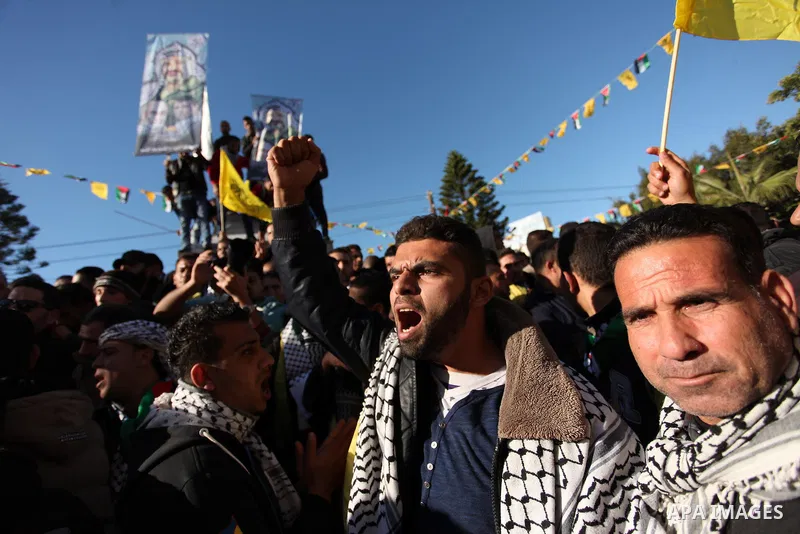 Supporters of the Fatah movement take part in a rally in Gaza City on December 31, 2016, marking the 52nd anniversary of its creation.. Photo by Ashraf Amra