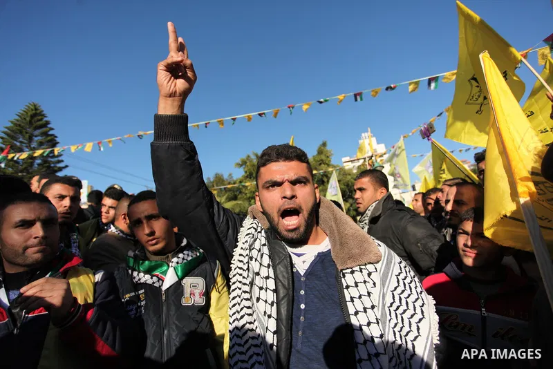 Supporters of the Fatah movement take part in a rally in Gaza City on December 31, 2016, marking the 52nd anniversary of its creation.. Photo by Ashraf Amra