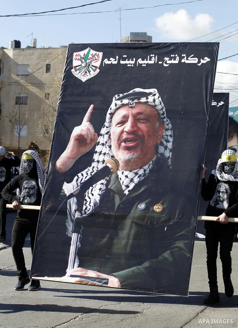 Palestinian supporters of the Fatah movement take part in a march to mark the 52nd anniversary of its creation in the West Bank City of Bethlehem, on January 1, 2017. Photo by Wisam Hashlamoun
