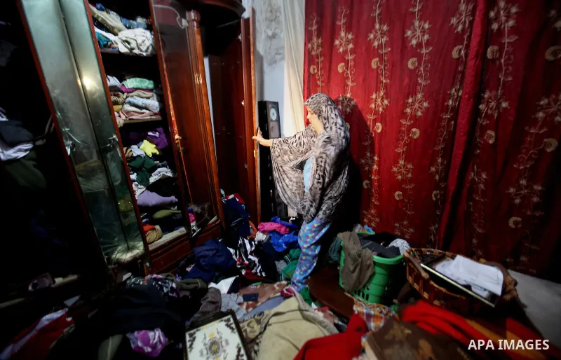A Palestinian woman inspects the damages at her house after an Israeli military operation, at Balata refugee camp naer in the West Bank city of Nablus, on January 3, 2017. Photo by Nedal Eshtayah