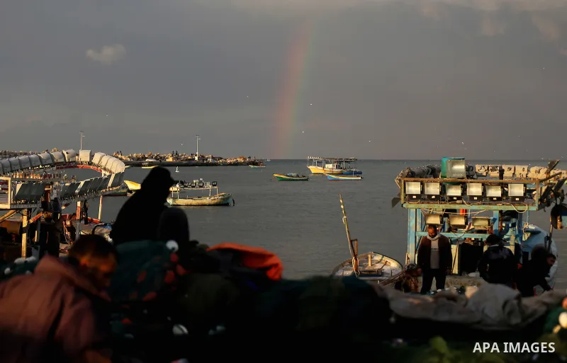 A rainbow is seen over the Mediterranean Sea during sunset, at the coast of Gaza beach, on January 04, 2017. Photo by Yasser Qudih