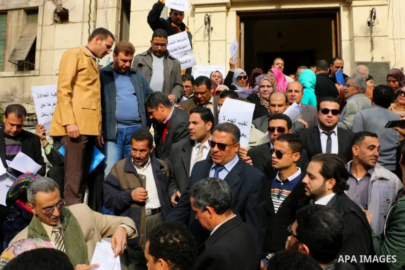 Egyptian lawyers hold placards during a protest against lawyers Syndicate head Sameh Ashour, in front of the syndicate lawyers, Cairo, Egypt, on January 05, 2017. Photo by Amr Sayed