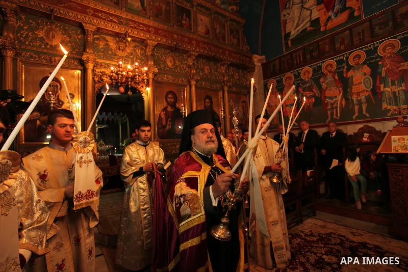 Palestinian Orthodox Christian altar boys attend a Christmas mass at the Saint Porphyrios Greek Orthodox church in Gaza City on January 7, 2017. According to the Gregorian calendar, Orthodox Christmas falls 13 days after...