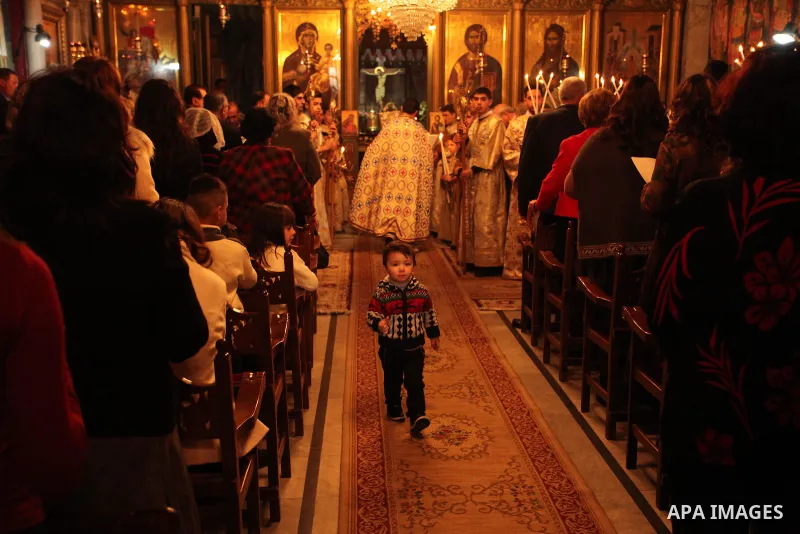 Palestinian Orthodox Christian altar boys attend a Christmas mass at the Saint Porphyrios Greek Orthodox church in Gaza City on January 7, 2017. According to the Gregorian calendar, Orthodox Christmas falls 13 days after...
