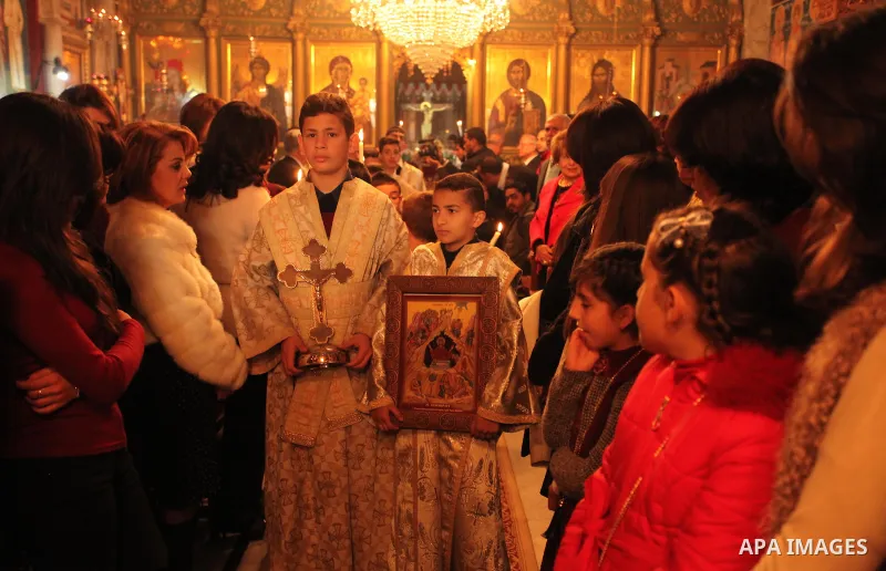 Palestinian Orthodox Christian altar boys attend a Christmas mass at the Saint Porphyrios Greek Orthodox church in Gaza City on January 7, 2017. According to the Gregorian calendar, Orthodox Christmas falls 13 days after...