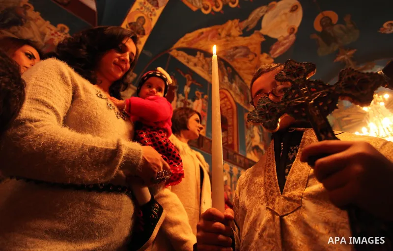Palestinian Orthodox Christian altar boys attend a Christmas mass at the Saint Porphyrios Greek Orthodox church in Gaza City on January 7, 2017. According to the Gregorian calendar, Orthodox Christmas falls 13 days after...