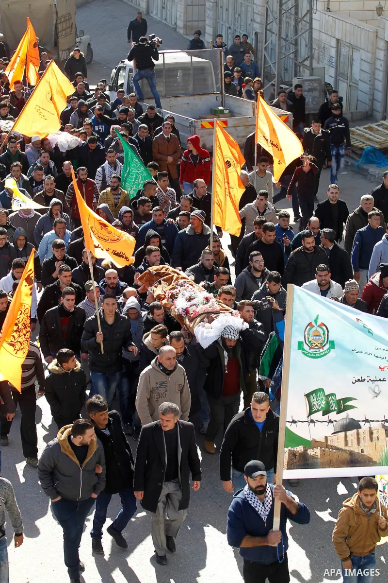 Mourners attend the funeral of Hatem al-Shalodi, a Palestinian who was killed after reportedly carrying out a stabbing attack on Israeli soldiers months ago, in the West Bank town of Hebron on January 7, 2017, after his...
