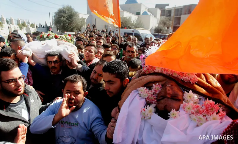 Mourners attend the funeral of Hatem al-Shalodi, a Palestinian who was killed after reportedly carrying out a stabbing attack on Israeli soldiers months ago, in the West Bank town of Hebron on January 7, 2017, after his...