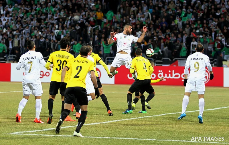 Palestinian players of Shabab Hebron and Players of Lebanese al-Ahed FC compete during their a second leg match of Arab championship for clubs at Amman international stadium, in Amman, Jordan, on January 12, 2017. Photo...