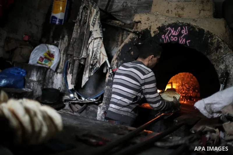 A Palestinian baker makes food using a wood-fired oven at his traditional bakery in Gaza January 12, 2017. Power shortages in the Palestinian enclave have occurred repeatedly in recent weeks, with homes in Gaza City typi...