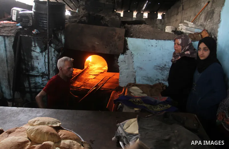 A Palestinian baker makes bread using a wood-fired oven at his traditional bakery in Rafah in the southern Gaza strip, on January 14, 2017. Power shortages in the Palestinian enclave have occurred repeatedly in recent we...