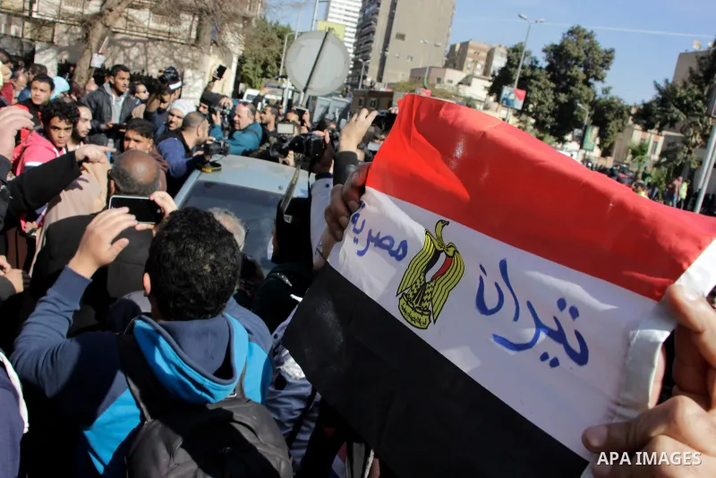 An Egyptian man celebrates with a national flag defaced with the words "Tiran is Egyptian" after the Supreme Administrative Court upheld on January 16, 2017 a ruling voiding a government agreement to hand over the two Re...