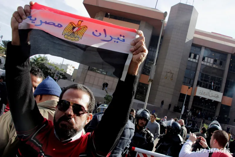 An Egyptian man celebrates with a national flag defaced with the words "Tiran is Egyptian" after the Supreme Administrative Court upheld on January 16, 2017 a ruling voiding a government agreement to hand over the two Re...