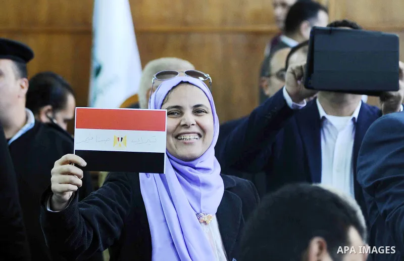 An Egyptian woman celebrates with a national flag defaced with the words "Tiran" and "Sanafir" after the Supreme Administrative Court upheld on January 16, 2017 a ruling voiding a government agreement to hand over the tw...