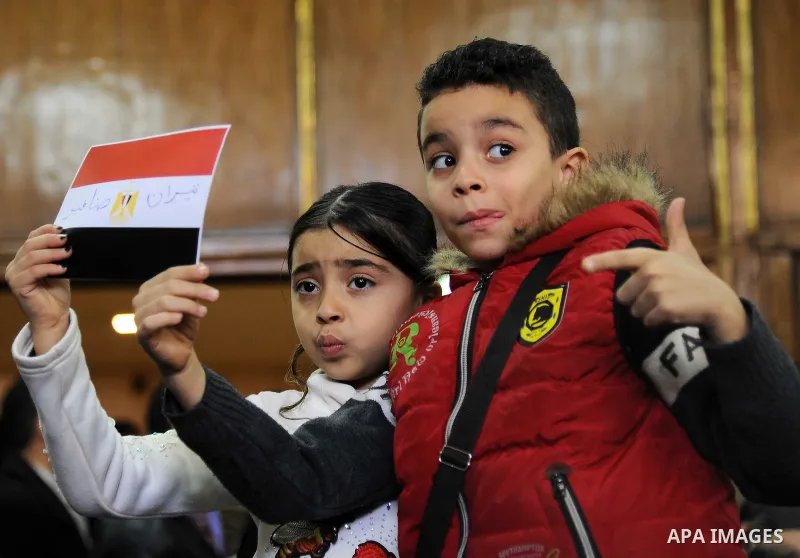 Egyptian children celebrate with a national flag defaced with the words "Tiran" and "Sanafir" after the Supreme Administrative Court upheld on January 16, 2017 a ruling voiding a government agreement to hand over the two...