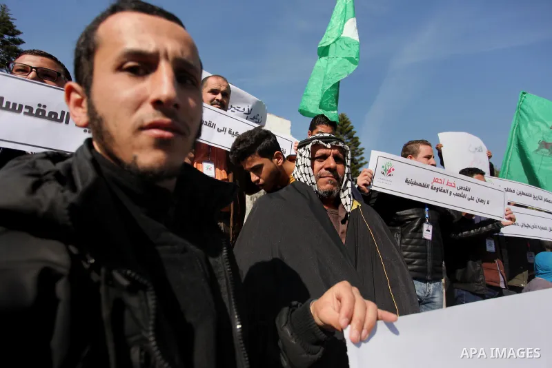Palestinians hold placards during a demonstration against proposed plans by President-elect Donald Trump to move the US embassy in Israel to Jerusalem, in Gaza city, on January 16, 2017. Photo by Ashraf Amra