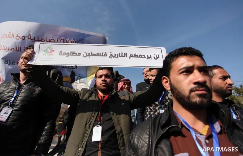 Palestinians hold placards during a demonstration against proposed plans by President-elect Donald Trump to move the US embassy in Israel to Jerusalem, in Gaza city, on January 16, 2017. Photo by Ashraf Amra