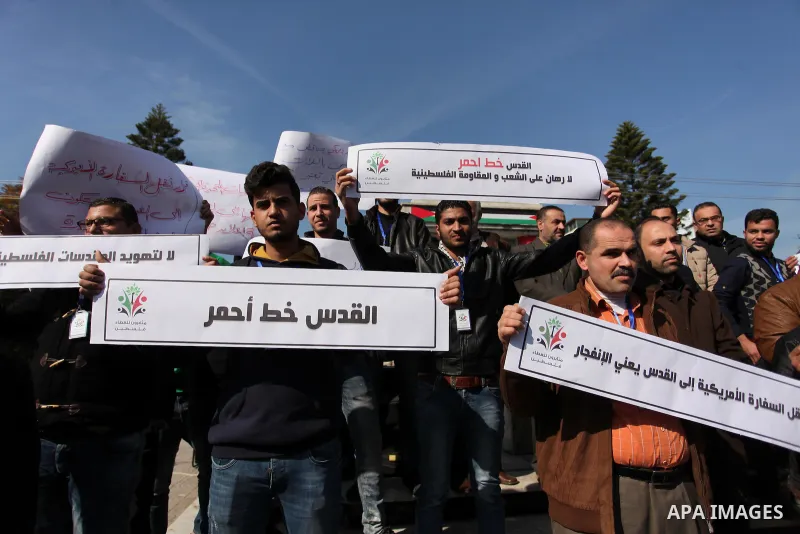 Palestinians hold placards during a demonstration against proposed plans by President-elect Donald Trump to move the US embassy in Israel to Jerusalem, in Gaza city, on January 16, 2017. Photo by Ashraf Amra
