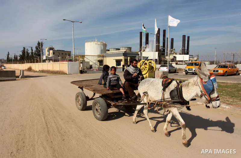 A Palestinian man rides his donkey-drawn cart in front of Gaza's power plant in Nuseirat in the central Gaza Strip January 16, 2017. Photo by Ashraf Amra