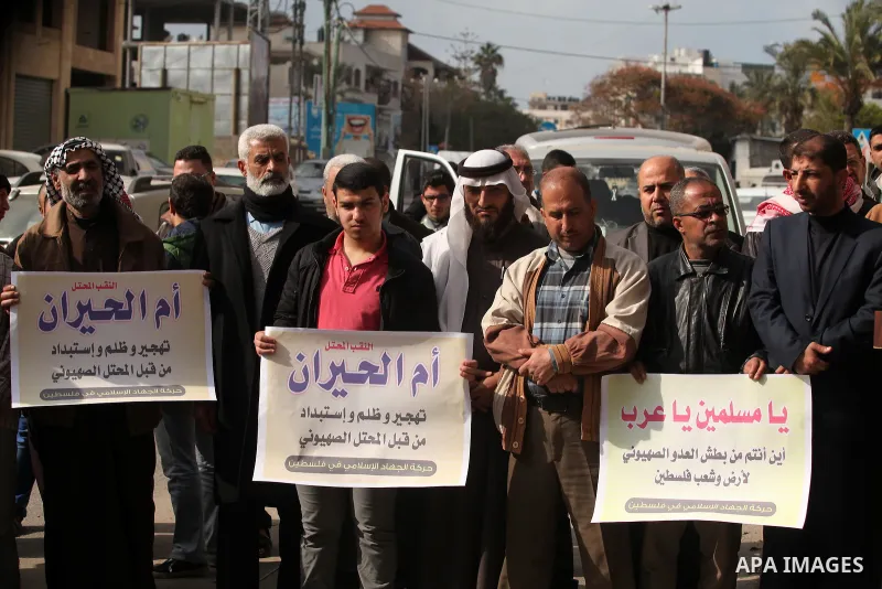 Palestinian supporters of the Islamic Jihad Movement, hold placards during a protest after Israeli police raided the unrecognized Bedouin village of Umm al-Hiran to evacuate residents in order to demolish their homes, in...