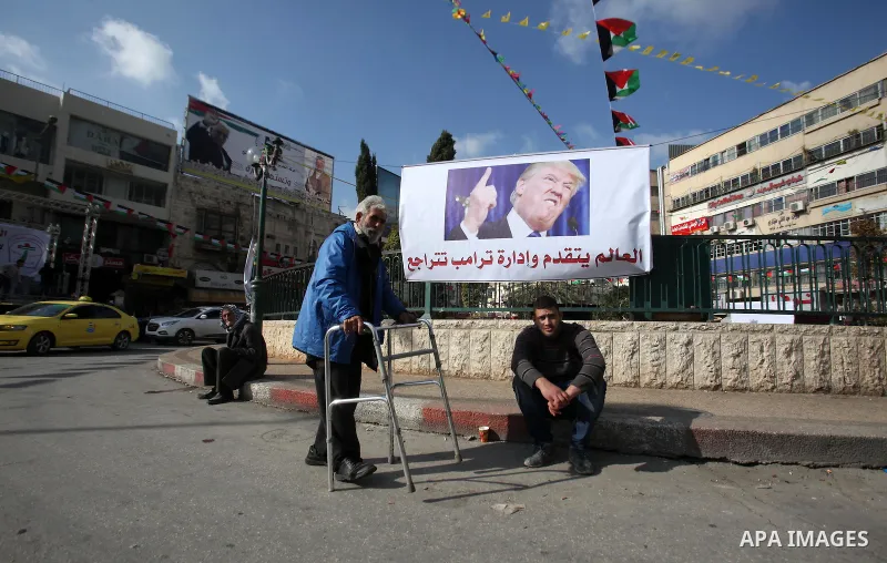 A Palestinian man walks past a banner against a promise by U.S. President-elect Donald Trump to relocate the U.S. embassy to Jerusalem, in the West Bank city of Nablus January 19, 2017. Photo by Nedal Eshtayah