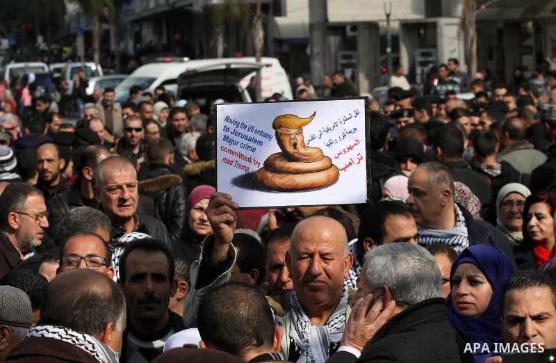 Palestinians hold palestine flags during a demonstration against proposed plans by President-elect Donald Trump to move the US embassy in Israel to Jerusalem, in the West Bank city of Nablus, on January 19, 2017. Photo b...