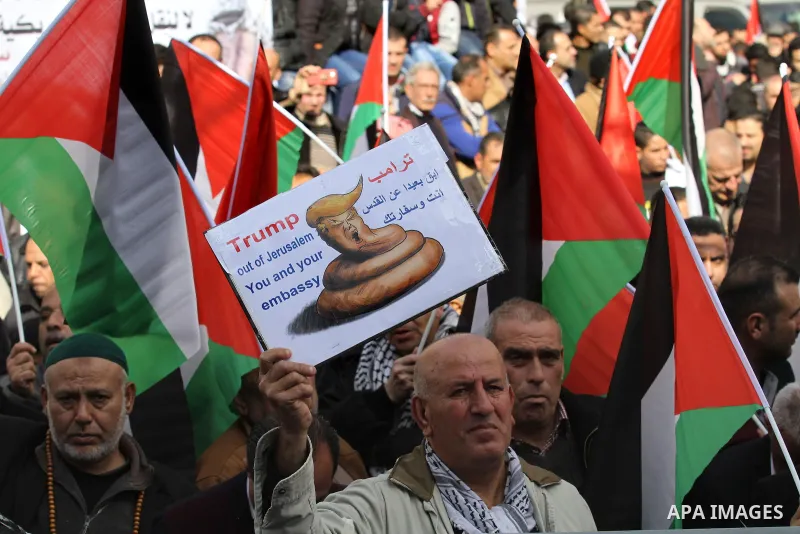 Palestinians hold palestine flags during a demonstration against proposed plans by President-elect Donald Trump to move the US embassy in Israel to Jerusalem, in the West Bank city of Nablus, on January 19, 2017. Photo b...