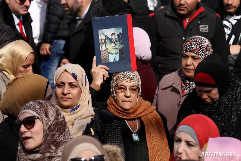 Palestinians hold palestine flags during a demonstration against proposed plans by President-elect Donald Trump to move the US embassy in Israel to Jerusalem, in the West Bank city of Nablus, on January 19, 2017. Photo b...