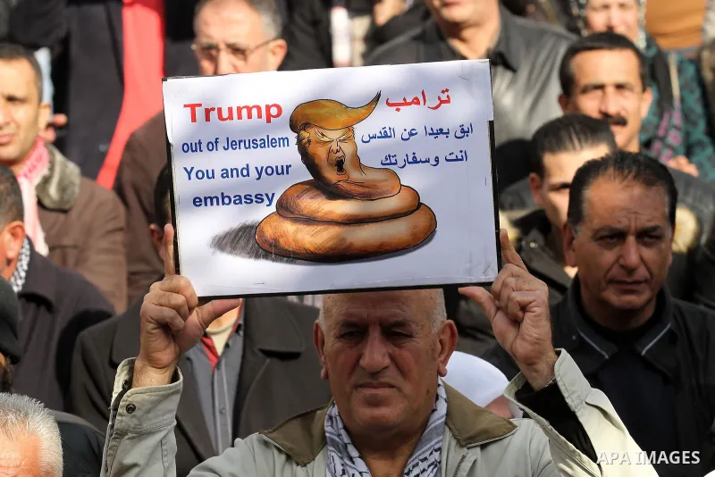 Palestinians hold palestine flags during a demonstration against proposed plans by President-elect Donald Trump to move the US embassy in Israel to Jerusalem, in the West Bank city of Nablus, on January 19, 2017. Photo b...