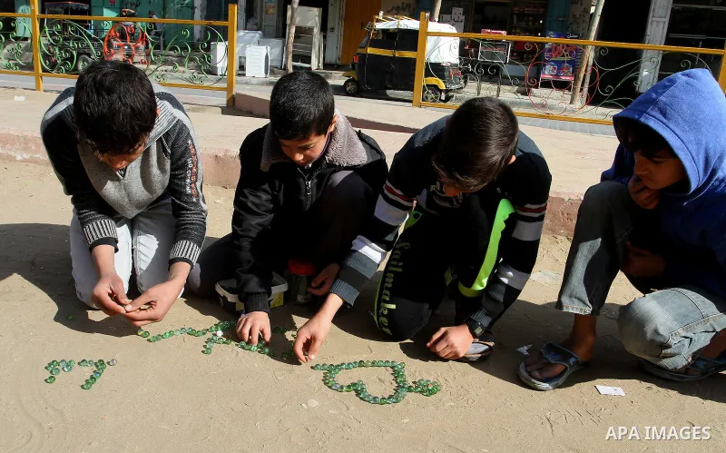 Palestinian children play marbles in a street in Rafah in the southern Gaza strip on January 19, 2017. Photo by Abed Rahim Khatib