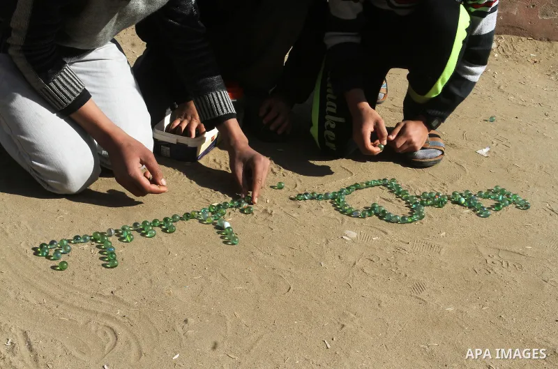 Palestinian children play marbles in a street in Rafah in the southern Gaza strip on January 19, 2017. Photo by Abed Rahim Khatib