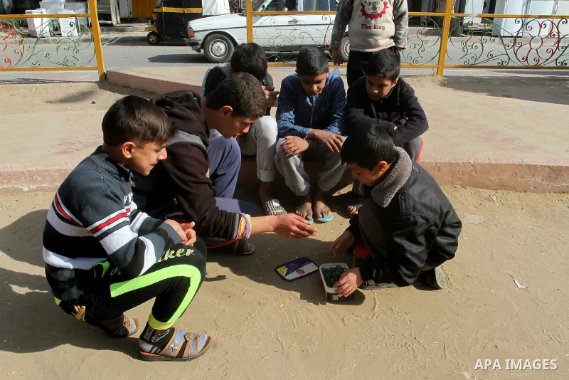 Palestinian children play marbles in a street in Rafah in the southern Gaza strip on January 19, 2017. Photo by Abed Rahim Khatib