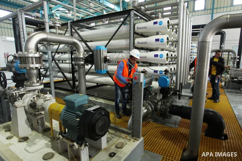 A Palestinian worker checks of pipes during the inauguration ceremony of The First Phase of the Seawater Desalination Plant-Southern Gaza completed with generous support from the European union Implemented by UNICEF in p...