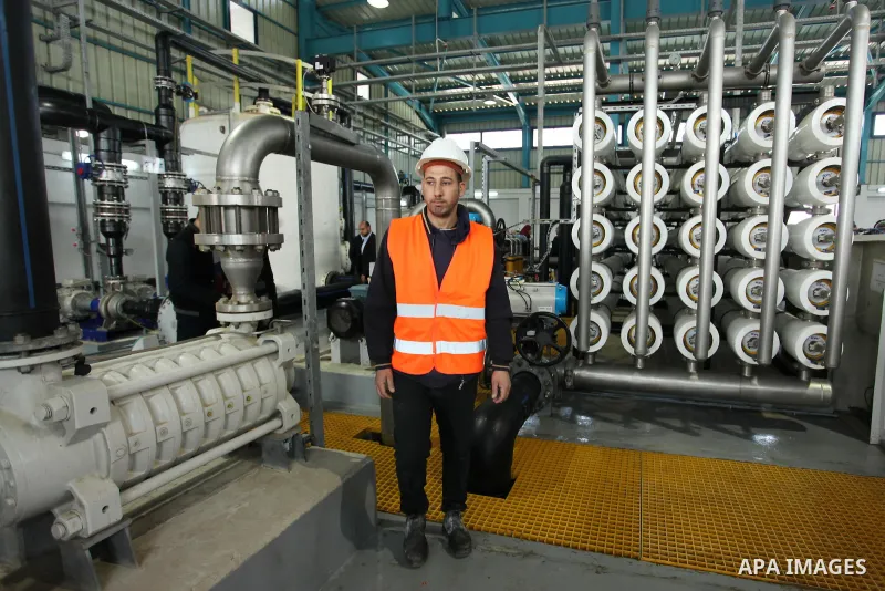 A Palestinian worker checks of pipes during the inauguration ceremony of The First Phase of the Seawater Desalination Plant-Southern Gaza completed with generous support from the European union Implemented by UNICEF in p...