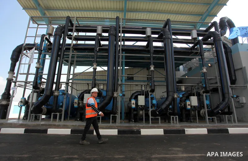 A Palestinian worker walks outside the Seawater Desalination Plant-Southern Gaza during the inauguration ceremony which completed with generous support from the European union Implemented by UNICEF in partnership with Pa...