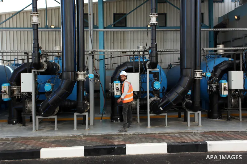 A Palestinian worker checks of pipes during the inauguration ceremony of The First Phase of the Seawater Desalination Plant-Southern Gaza completed with generous support from the European union Implemented by UNICEF in p...
