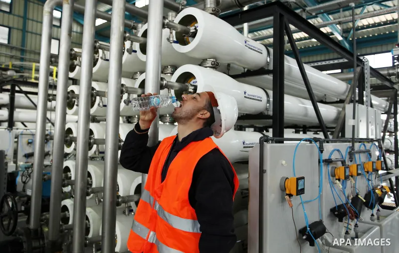 A Palestinian worker drinks water extracted form the First Phase of the Seawater Desalination Plant-Southern Gaza completed with generous support from the European union Implemented by UNICEF in partnership with Palestin...