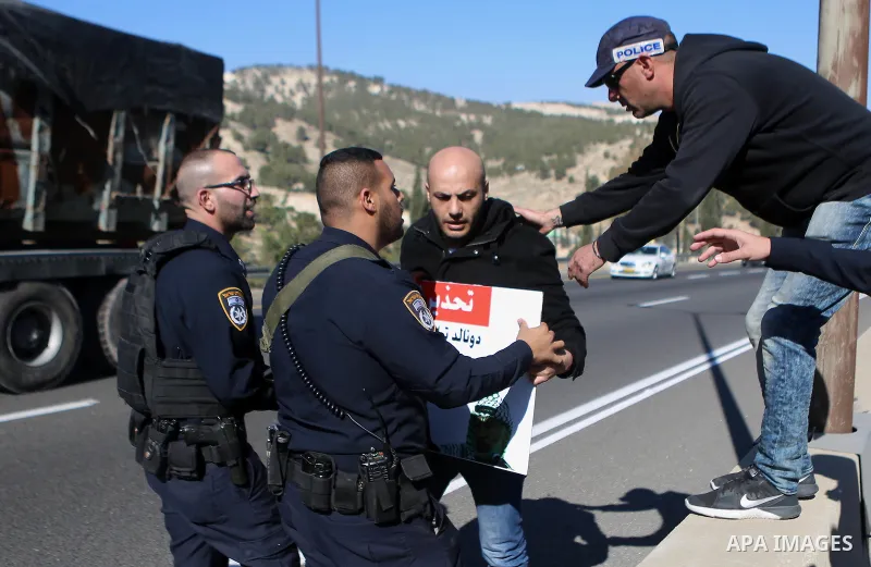Israeli police detain a Palestinian protester during a demonstration against the construction of Jewish settlements in the occupied West Bank and against US President-elect Donald Trump, on January 20, 2017, near the set...