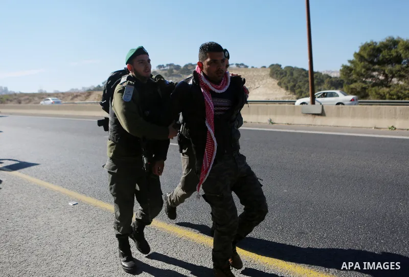 Israeli police detain a Palestinian protester during a demonstration against the construction of Jewish settlements in the occupied West Bank and against US President-elect Donald Trump, on January 20, 2017, near the set...