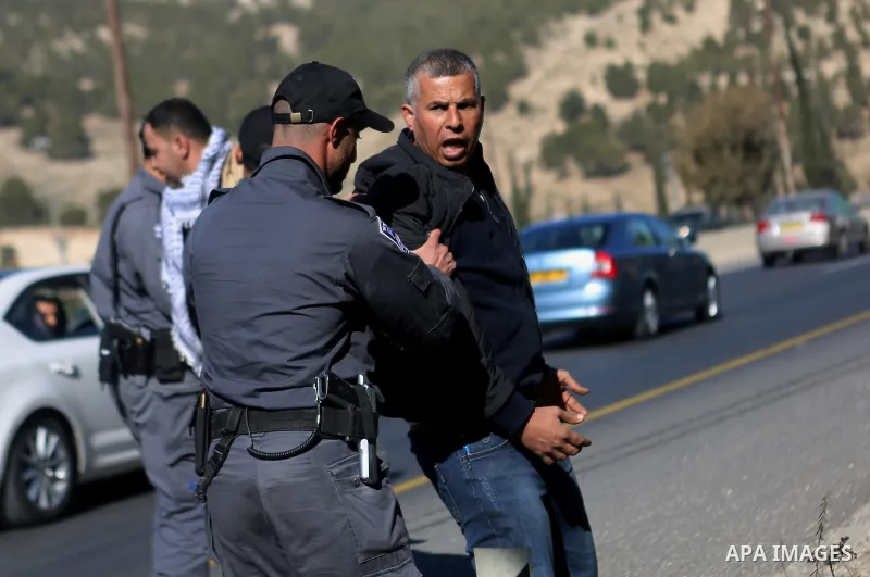 Israeli police detain a Palestinian protester during a demonstration against the construction of Jewish settlements in the occupied West Bank and against US President-elect Donald Trump, on January 20, 2017, near the set...