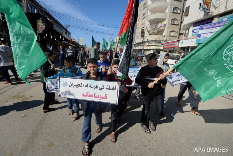 Palestinian children hold placards during a protest against proposed plans by President-elect Donald Trump to move the US embassy in Israel to Jerusalem, and against the power crisis, and to show solidarity with Palestin...