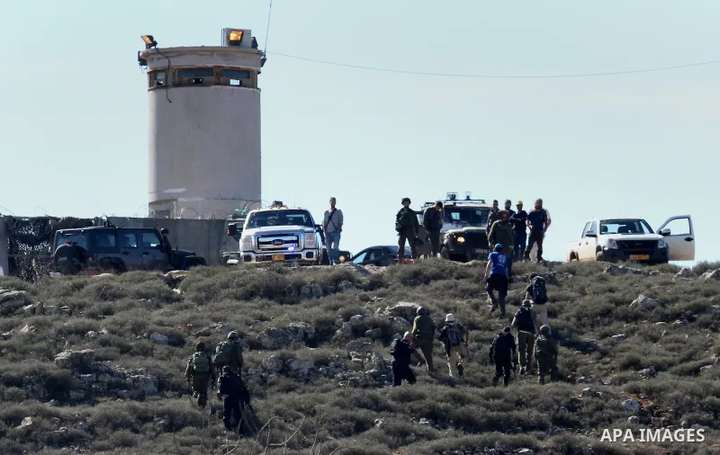 Israeli security forces accompany four Israeli settlers after they was detain for briefly by Palestinian farmers in the West Bank village of Qasra near Nablus, on January 20, 2017. According to reports, the Palestinian v...