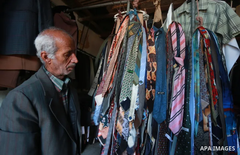A Palestinian man looks at second hand clothes at a market in Gaza city, on January 21, 2017.Due to the current economic situation in Gaza Strip, many of the Palestinians resort to meet their needs of used goods. Photo b...