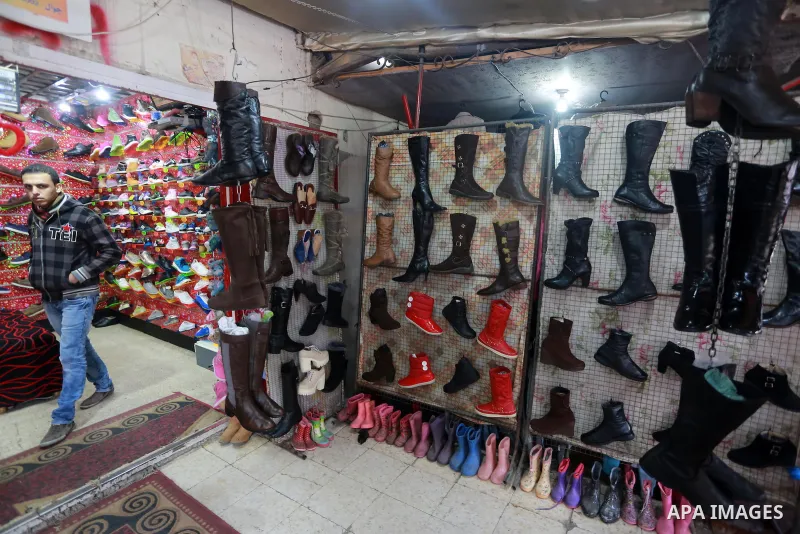 A Palestinian man looks at second hand clothes at a market in Gaza city, on January 21, 2017.Due to the current economic situation in Gaza Strip, many of the Palestinians resort to meet their needs of used goods. Photo b...