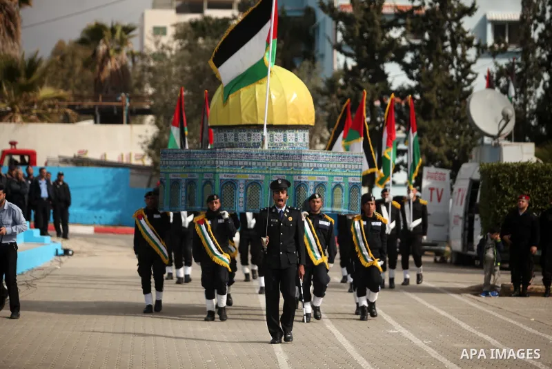 Palestinian policemen march during a graduation ceremony in Gaza City on January 21, 2017. Photo by Ashraf Amra